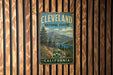A vintage metal sign for Cleveland National Forest in California, featuring a scenic mountain landscape.