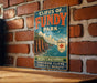 A vintage-style sign for Cliffs of Fundy Park, featuring a scenic image of the park's cliffs and surrounding nature.