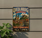 A vintage metal sign advertising Quedlinburg, Germany, featuring a colorful illustration of the city's architecture and landmarks.