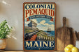 A vintage-style metal sign advertising the Colonial Pemaid State Historic Site in Maine, featuring a cannon and a ship on a rocky coastline.