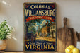 A vintage-style metal sign for Colonial Williamsburg, Historic Area, featuring an illustration of a street scene with a horse-drawn carriage and buildings.