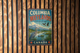 A vintage-style metal sign for Columbia Wetlands, a wildlife sanctuary in Canada, featuring a serene landscape with a bird, a lake, and mountains in the background.