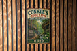 A vintage-style metal sign for Conkles Hollow State Nature Preserve in Ohio, featuring a scenic image of a forest and a winding path.