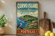 a vintage-style sign for Corvo Island, Portugal, with a coastal landscape and a bird perched on a rock.