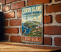 a vintage-style sign for Corvo Island, Portugal, mounted on a brick wall.