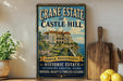 A vintage-style sign for Crane Estate at Castle Hill in Ipswich, Massachusetts, featuring an illustration of a historic mansion overlooking the ocean.