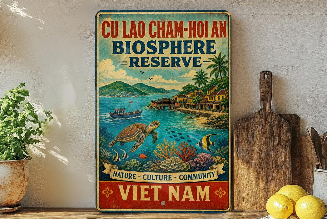 a vintage-style sign for the Cu Lao Cham-Hôan Biosphere Reserve, which is a nature reserve in Vietnam. The sign is displayed on a wall, surrounded by various objects such as a potted plant, a wooden cutting board, and some fruits like lemons.