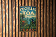 A vintage-style metal sign with the text "Cuchillas del Toa" and "Biosphere Reserve Cuba" is displayed on a wooden wall.