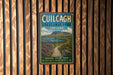a vintage-style sign for Cuilcag Lakelands Park, Ireland, mounted on a wooden wall.