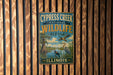 A vintage-style metal sign for the Cypress Creek National Wildlife Refuge in Illinois, featuring an illustration of wildlife in a natural setting.