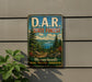 A vintage metal sign for the D.A.R. State Forest in Massachusetts, featuring a scenic landscape with pine trees, a lake, and mountains.