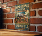 A vintage-style metal sign for Dana Thomas House in Springfield, Illinois, featuring an illustration of the house and the text "Dana Thomas House Frank Lloyd Wright Masterpiece" and "Springfield Illinois".