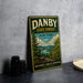A vintage-style sign for Danby State Forest in New York, featuring a scenic landscape with pine trees, mountains, and a lake.