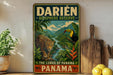 A vintage-style sign advertising the Darién Biosphere Reserve in Panama, featuring a leopard and a toucan in a lush, tropical landscape.