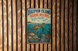 A vintage metal sign for Dauphin Island Marine Reserve, Alabama, featuring an illustration of a turtle swimming in the ocean.