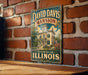 A vintage-style metal sign for the David Davis mansion in Bloomington, Illinois, mounted on a brick wall.