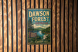 A vintage metal sign for Dawson Forest in Georgia, featuring a scenic landscape with a river, mountains, and pine trees.
