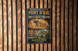 a vintage metal sign with text and an illustration of a cave with a bull.