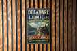 A vintage metal sign for the National Heritage Corridor in Pennsylvania, featuring a train and a scenic landscape.
