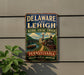 A vintage-style metal sign for the National Heritage Corridor in Delaware and Lehigh, featuring a train and a scenic landscape.