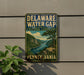 A vintage-style sign for the Delaware Water Gap in Pennsylvania, featuring a scenic landscape with a river and mountains.