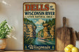 A vintage-style metal sign for the "Dells of the Wisconsin River State Natural Area" is displayed on a wall, featuring a scenic illustration of a boat on the river and a rocky landscape.