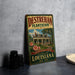 A vintage-style metal sign for "Destrehan Plantation" in Louisiana, featuring a house and flowers, is displayed on a gray countertop.