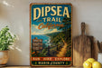 A vintage-style metal sign for the Dipsea Trail in California, featuring a scenic image of a coastal path surrounded by lush greenery.