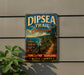 A vintage metal sign for the Dipssea Trail in California, featuring a scenic image of a coastal path surrounded by lush greenery.