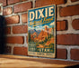 A vintage metal sign for the Dixie National Forest in Utah, featuring a scenic illustration of the landscape with mountains and forests.