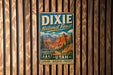 A vintage metal sign for Dixie National Forest in Utah, featuring a scenic mountain landscape and the text "Dixie National Forest" prominently displayed.