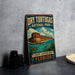 A vintage-style sign for Dry T guitars National Park in Fort Jefferson, Florida, featuring an illustration of a building and a turtle in the water.