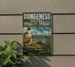 A vintage-style metal sign for the Dungeness National Wildlife Refuge, featuring a lighthouse, birds, and a mountain landscape.