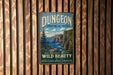 A vintage metal sign for Dungeon Provincial Park, featuring a scenic landscape with cliffs and a pine tree, hangs on a wooden wall.
