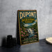 A vintage-style sign for DuPont State Recreational Forest in North Carolina, featuring a scenic image of a waterfall and surrounding landscape.