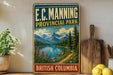A vintage-style sign for E.C. Manning Provincial Park in British Columbia, Canada, featuring a scenic mountain landscape with a lake and pine trees.