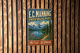 A vintage-style metal sign for E.C. Manning Provincial Park in British Columbia, Canada, featuring a scenic mountain landscape.