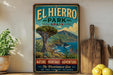 A vintage-style sign for El Hierro Park, Spain, featuring a scenic landscape with mountains, palm trees, and a blue sky.