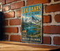 A vintage-style metal sign for the Elk Lakes Provincial Park in British Columbia, Canada, featuring a scenic mountain landscape with a moose and a lake.