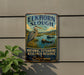 A vintage-style metal sign for the National Estuarine Research Reserve in California, featuring an illustration of a heron and a boat on a body of water.