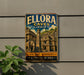 A vintage-style sign for Ellora Caves in India, featuring an illustration of ancient structures and a large elephant.