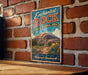 A vintage-style metal sign for the Enchanted Rock State Natural Area in Texas, featuring a scenic image of the rock formation and desert landscape.