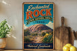 A vintage-style sign for the Enchanted Rock State Natural Area in Texas, featuring a desert landscape with a cactus and a mountain in the background.