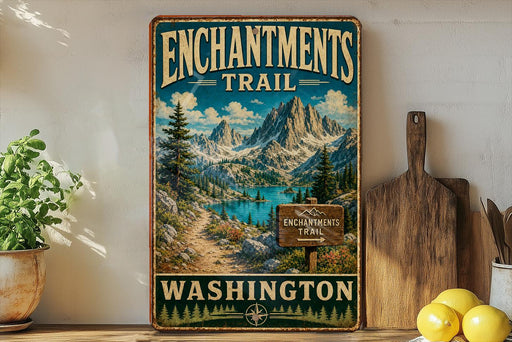 A vintage-style metal sign for the Enchanted Trail in Washington, featuring a scenic mountain landscape with a lake and pine trees.
