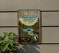 A vintage-style metal sign for Escanaba River State Forest in Michigan, featuring a scenic illustration of a river surrounded by pine trees and mountains.