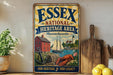 A vintage-style sign for the Essex National Heritage Area in Massachusetts, featuring illustrations of a red brick house, a sailboat, and a lobster.