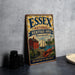 A vintage-style metal sign for the Essex National Heritage Area in Massachusetts, featuring illustrations of a lighthouse, a house, a boat, and a lobster.