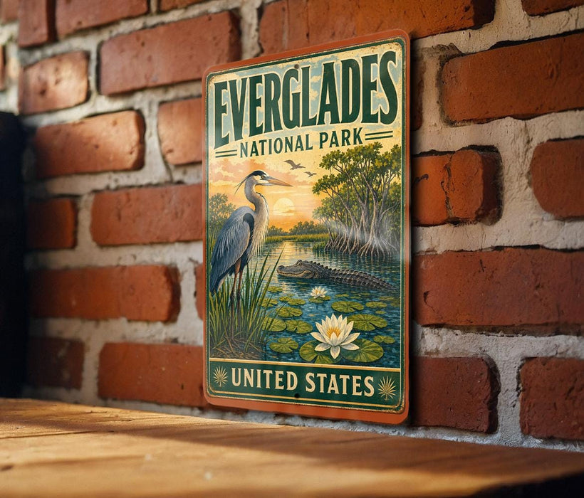 A vintage-style metal sign for Everglades National Park, featuring an illustration of a bird, a water lily, and a crocodile, is mounted on a brick wall.
