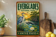a vintage-style sign for Everglades National Park, with a painting of a heron and a swampy landscape, along with the text "EVERGLADES NATIONAL PARK" and "UNITED STATES".