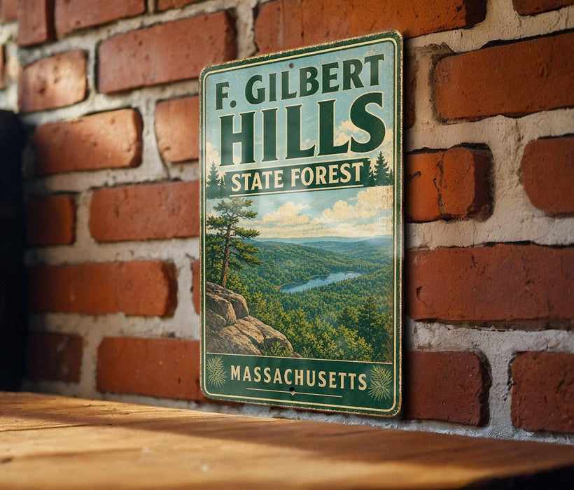 A vintage-style metal sign for F. Gilbert Hills State Forest in Massachusetts, featuring a scenic landscape with a river and pine trees.
